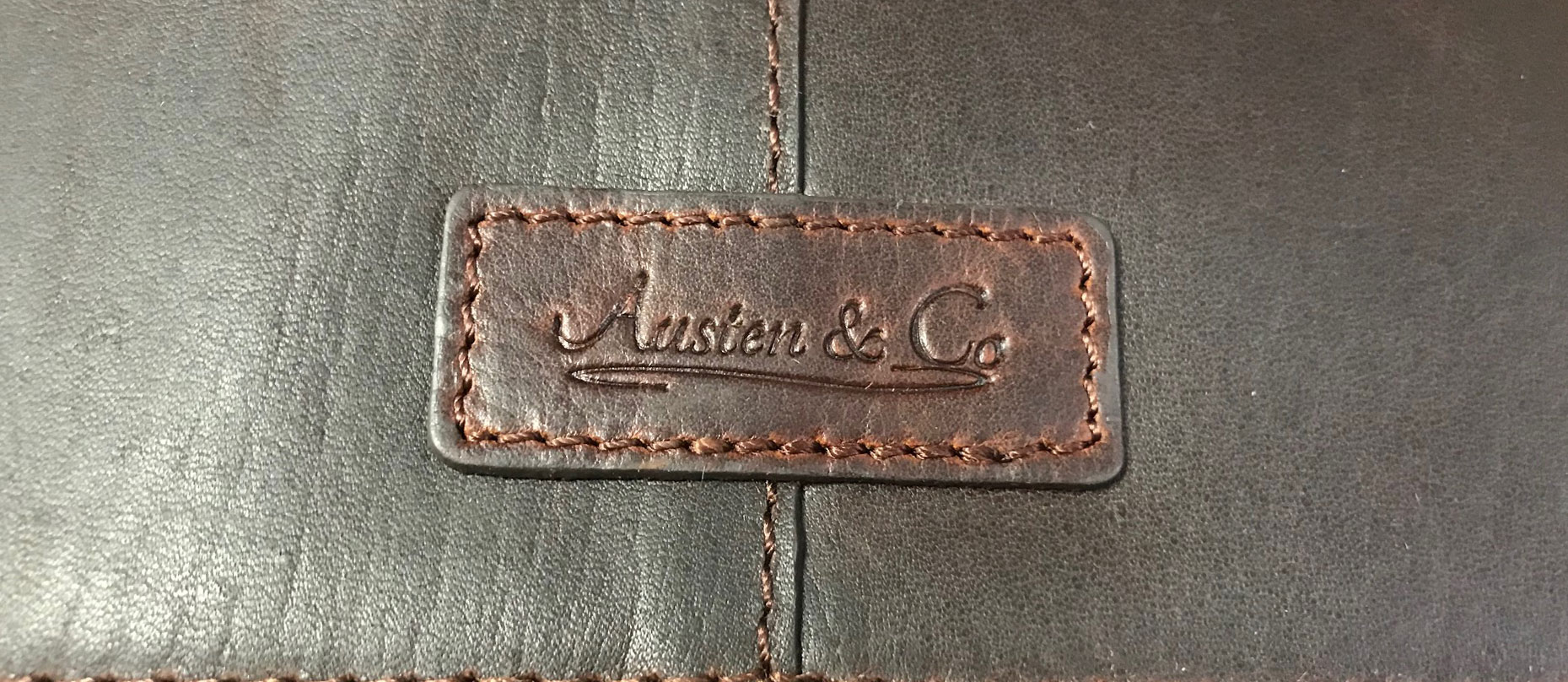 Brown Suit Carrier Austen & Co Logo